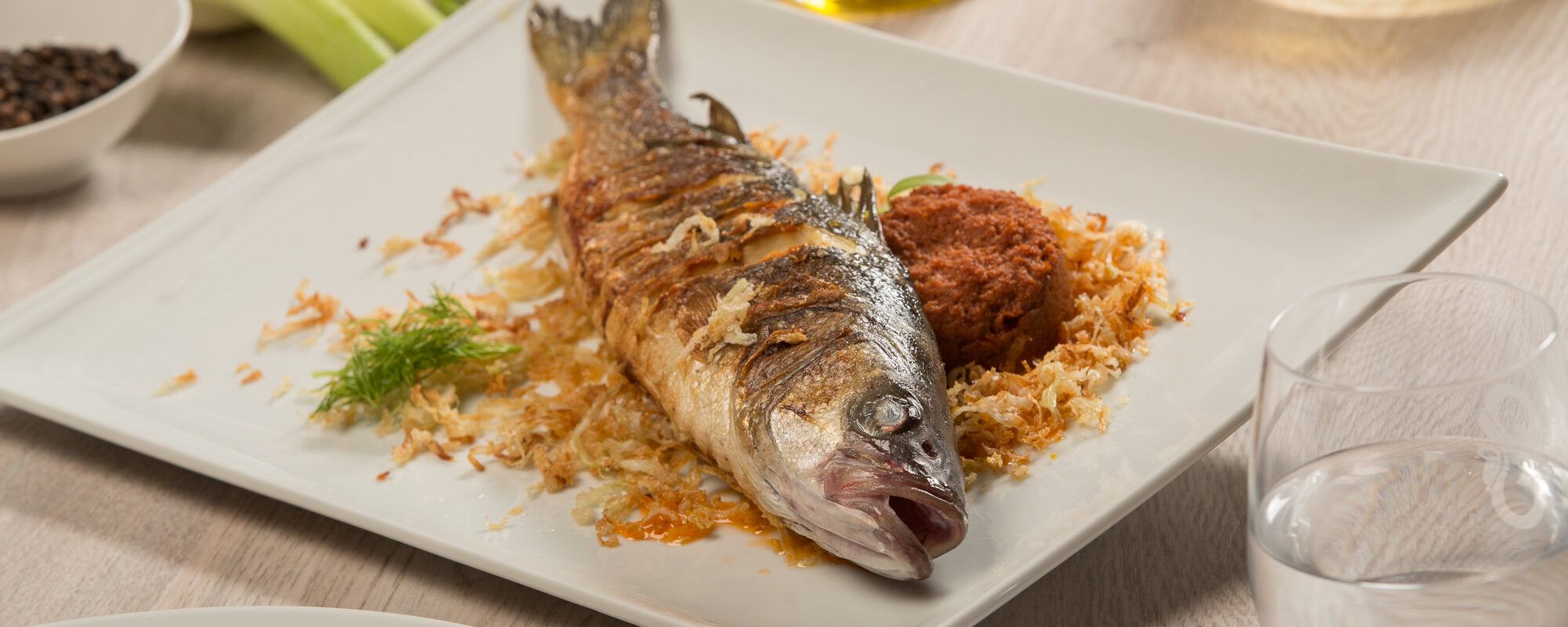 Roasted sea bass on a bed of fennel with a dried tomato sauce