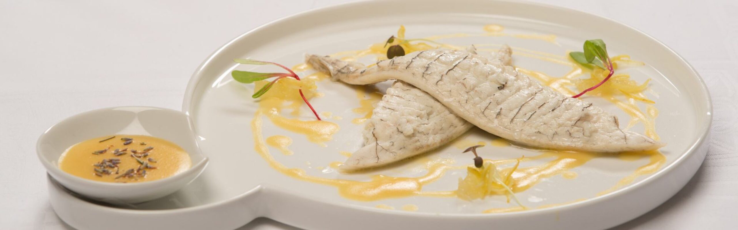 Poached sea bream with a creamy lavender and lemon sauce